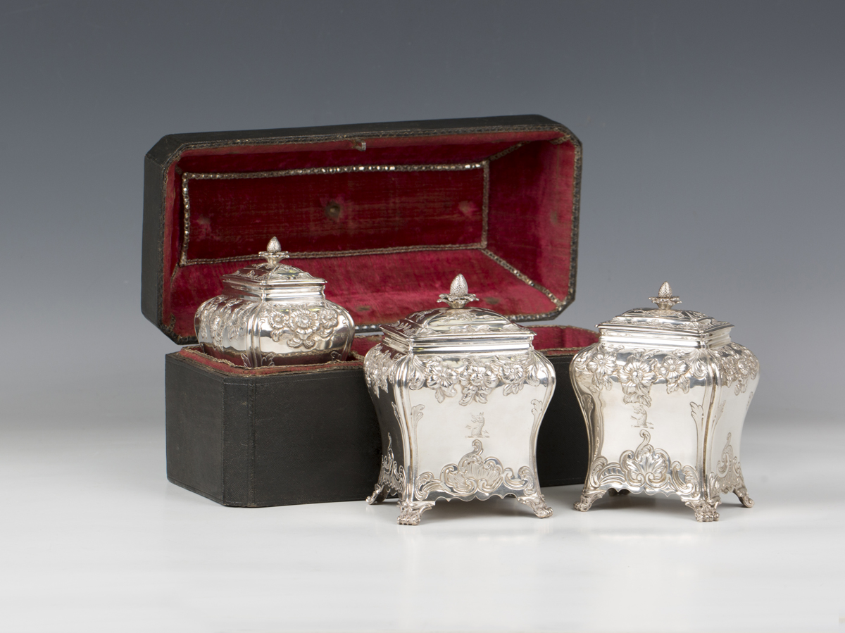 A set of three George III silver graduated tea caddies and covers with strawberry finials, each of