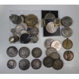 A collection of British coins and medallions, including a George III crown 1819 (with traces of