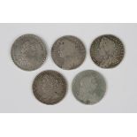 A group of British coins, comprising a George III one-shilling-and-sixpence bank token 1812 and four