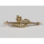 An Edwardian gold and seed pearl brooch, designed as a floral spray, detailed '15ct', weight 2.6g,