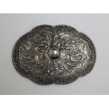 A Chinese silver two-piece waist belt buckle of shaped oval form, decorated with dragons within