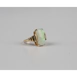 A gold ring, claw set with a cut cornered rectangular opal between stepped shoulders, detailed '