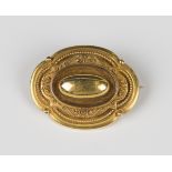 A Victorian gold shaped oval brooch in the classical taste with applied bead and wirework