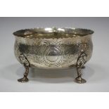 A Victorian silver circular bowl, engraved with flowers and foliate scrolls, raised on beaded and '