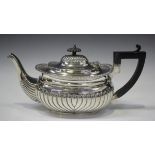 A late Victorian silver teapot of half spiral reeded cushion form, Birmingham 1897 by Thomas