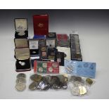 A collection of mostly modern British commemorative coins, including crowns and a few five pounds