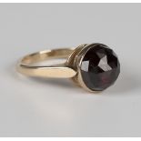 A Bohemian garnet single stone ring, mounted with the faceted Bohemian garnet within a closed back