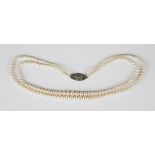 A two row necklace of graduated cultured pearls on a silver, green and colourless paste clasp,