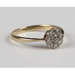 A gold and diamond nine stone cluster ring, mounted with the principal cushion cut diamond within