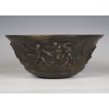 A German brown patinated bronze bowl, decorated with a continuous scene of playing fauns, possibly