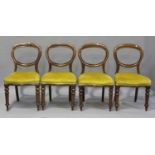 A matched set of eight Victorian mahogany balloon back dining chairs, the overstuffed seats on