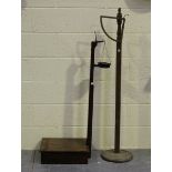A set of early 20th century oak floor-standing weighing scales with brass tray, height 118cm,