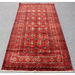A Pakistan Turkoman design rug, mid-20th century, the claret field with overall offset columns of