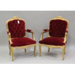 A pair of 20th century Louis XV style gilt painted showframe fauteuil armchairs, upholstered in