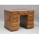 An Edwardian walnut twin pedestal desk, fitted with nine drawers, on plinth bases, height 76cm,