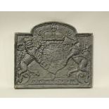 A 20th century cast iron fire back, decorated in relief with a royal coat of arms, height 51cm,