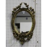 A late Victorian gilt gesso framed oval girandole wall mirror with stiff leaf spray surmount and two