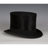 An early 20th century black moleskin top hat by Tress & Co Ltd, London, for A.J. Ridley & Son Ltd,