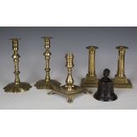 A pair of George III brass candlesticks, height 20cm, together with another pair of George III brass