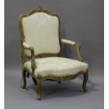 A 19th century French giltwood showframe fauteuil armchair with carved scroll decoration, on