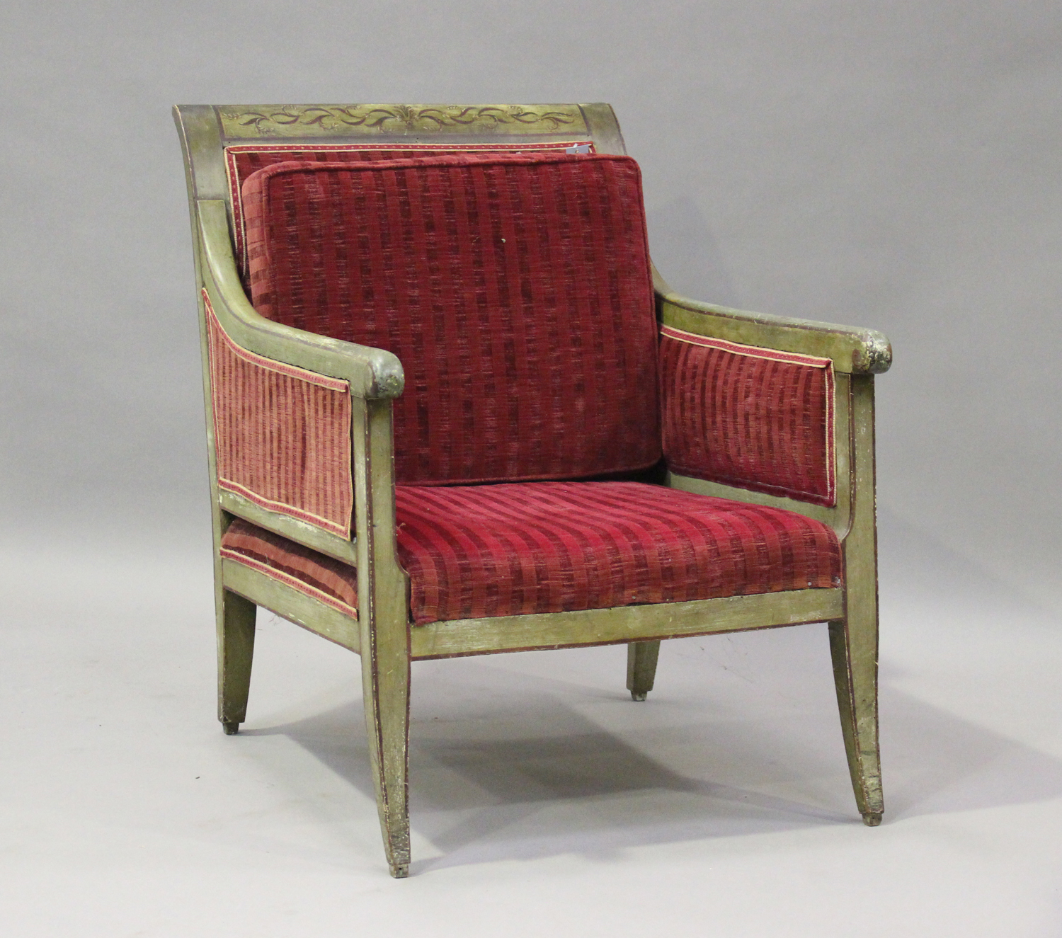 A 19th century Swedish green painted scroll armchair with foliate decoration, upholstered in red