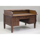 A George V oak roll-top desk, fitted with six drawers, on block legs, height 97cm, width 152cm,