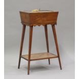 A late Victorian rosewood bijouterie table with inlaid decoration, the double hinged lid raised on