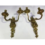 A pair of late 19th/early 20th century cast gilt metal two-branch wall lights, height 44cm.Buyer’s