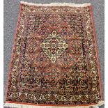 A Senneh rug, North-west Persia, late 20th century, the ink blue field with a stepped medallion,