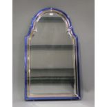 An Art Deco arched wall mirror with a sectional blue and peach tinted border, 109cm x 62cm.Buyer’s