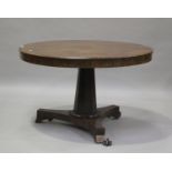 A Regency rosewood circular tip-top centre table, raised on a tapering octagonal column, on scroll