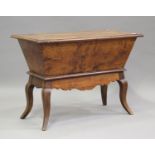 A 19th century Continental elm and fruitwood dough bin, the removable lid above shaped legs,