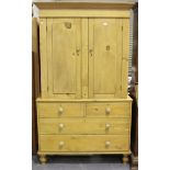 A late Victorian pine linen press, fitted with a pair of panel doors above two short and two long