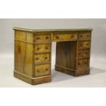 A Victorian burr walnut twin pedestal dressing table, fitted with an arrangement of drawers,