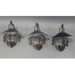 A set of three early 20th century wrought iron ceiling lights with painted tin shades, height