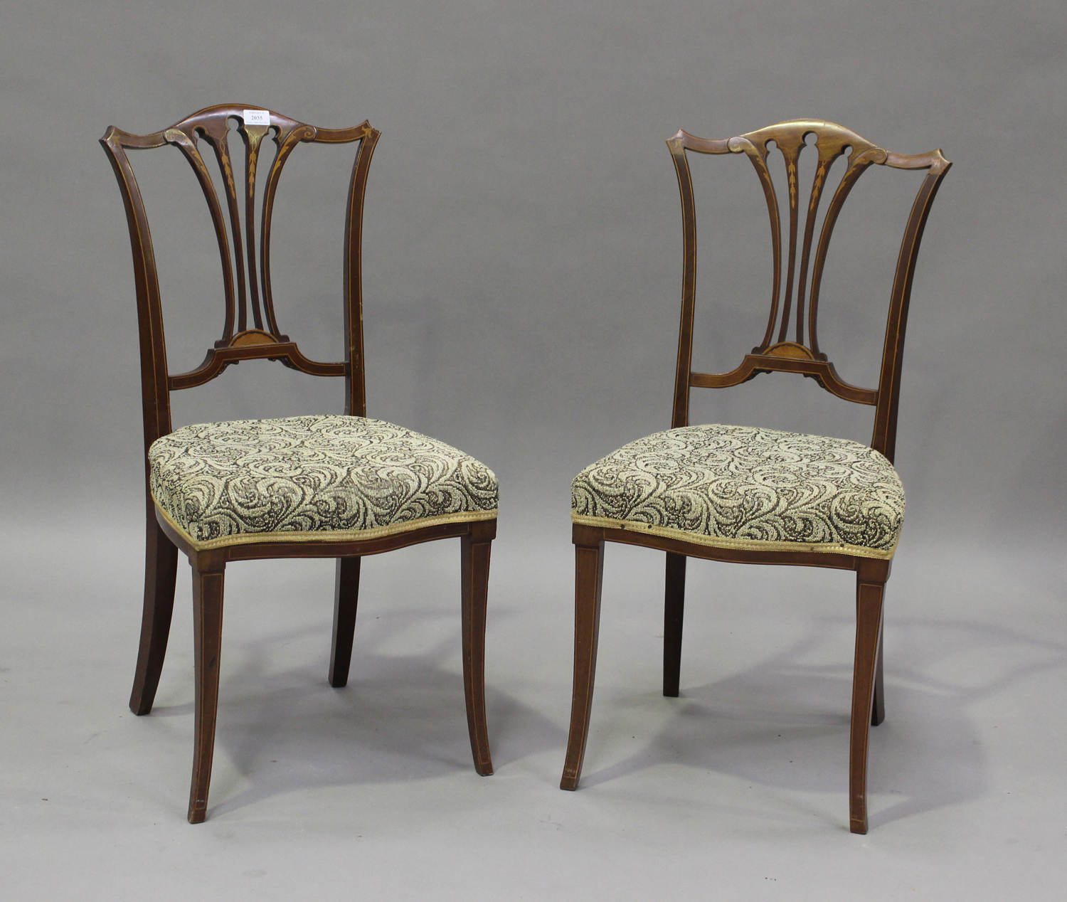 A pair of Edwardian mahogany and boxwood line inlaid bedroom chairs by Maple & Co, height 89cm,