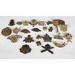 A small collection of early 20th century military cap badges and other titles, including Army