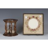 A 20th century mahogany framed triple glass egg timer, the two ends inset with ceramic plaques,