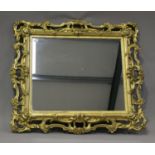 A mid/late Victorian carved gilt wood and gesso framed wall mirror, decorated with leaf and 'C'