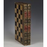 A late Victorian leather bound folding chess and backgammon board, width 43cm, and four playing card