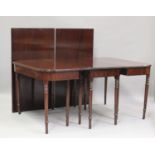 A George III mahogany dining table with central additional section and two extra leaves, on turned