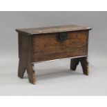 A late 17th century oak six-plank coffer, the hinged lid above a steal lockplate and incised