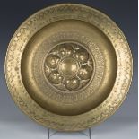 An 18th/19th Nuremberg brass circular charger with embossed decoration, diameter 41cm.Buyer’s