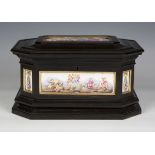 A 19th century ebonized canted rectangular casket with Capodimonte porcelain mounted panels, the