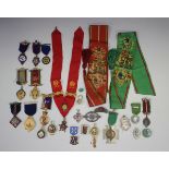 A collection of medals, badges and fobs, including many enamelled and a few silver issues,