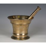 An 18th century bell metal pestle and mortar, length of pestle 24cm, height of mortar 14.3cm.Buyer’s