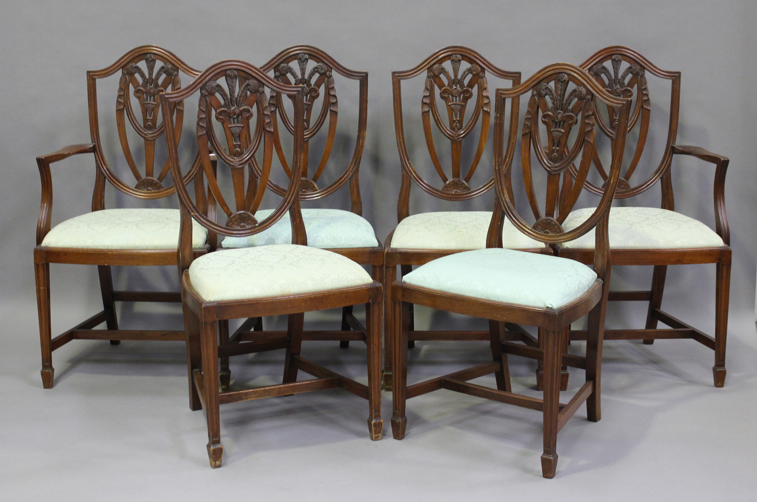 A set of six 20th century reproduction mahogany dining chairs with drop-in seats, comprising two