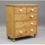 A Victorian pine chest of two short and three long drawers with china handles, height 114cm, width