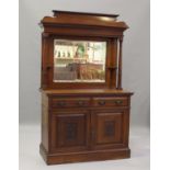 An Edwardian Arts and Crafts mahogany mirror back side cabinet, fitted with two drawers above a