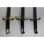 A group of three 1856 pattern Enfield sword bayonets with recurved single-edged fullered blades,